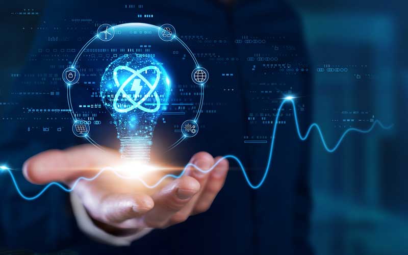 icon of a glowing atom surrounded by light resting on a hand